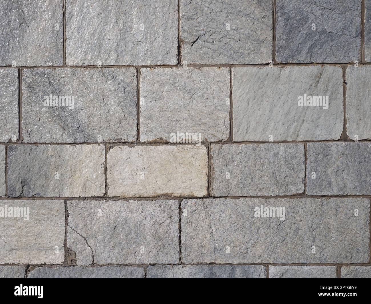 grey stone wall useful as a background Stock Photo - Alamy