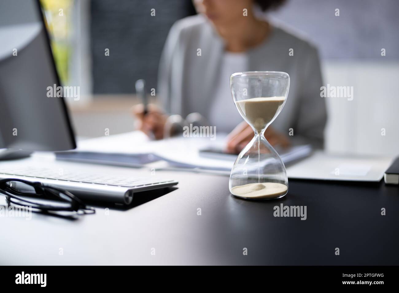 Late Invoice And Billing Deadline With Hourglass At Desk Stock Photo ...