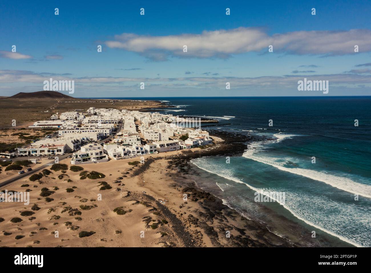 Landscape panorama of La Caleta de Famara and fire mountain, Lanzarote, Lanzarote, the Canary islands, Spain Stock Photo