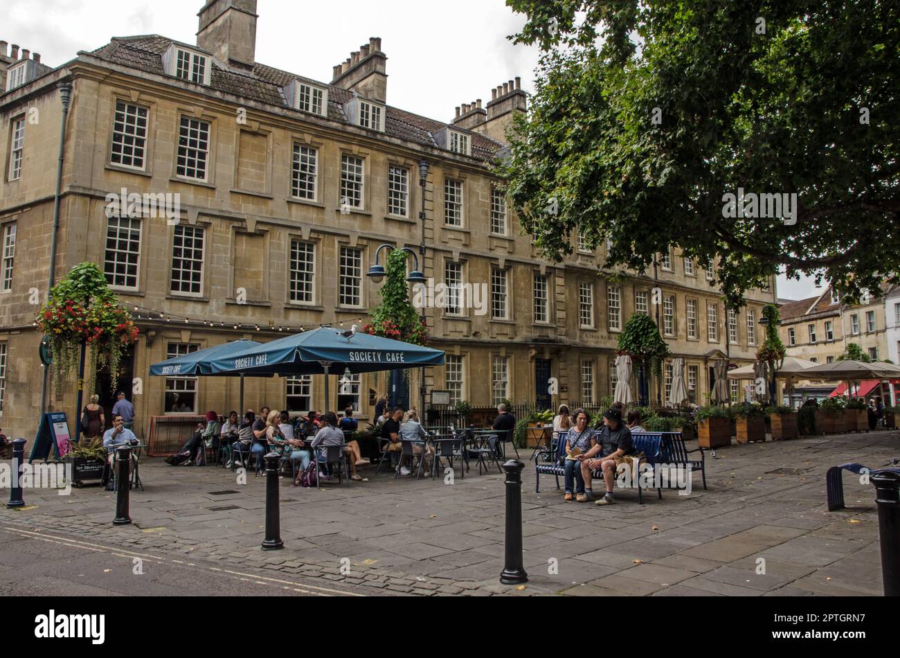 Bath, UK - September 3, 2022: People enjoying the autumn warmth despite the cloudy weather on an afternoon in the Kingsmead area of Bath city centre, Stock Photo