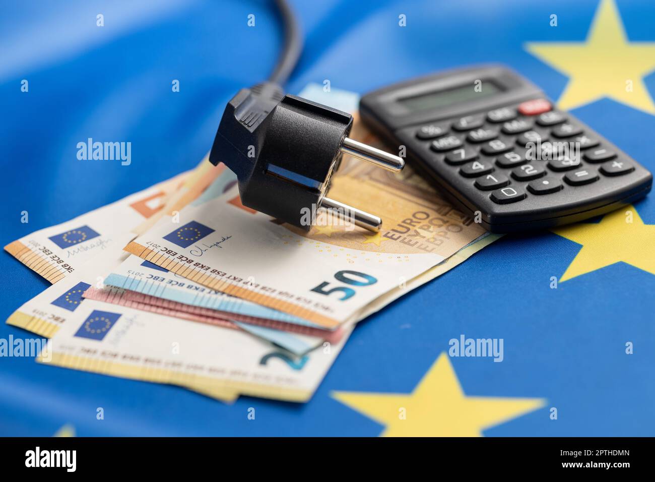 Electric plug and euro money on the european union flag. Concept of energy crisis. Stock Photo