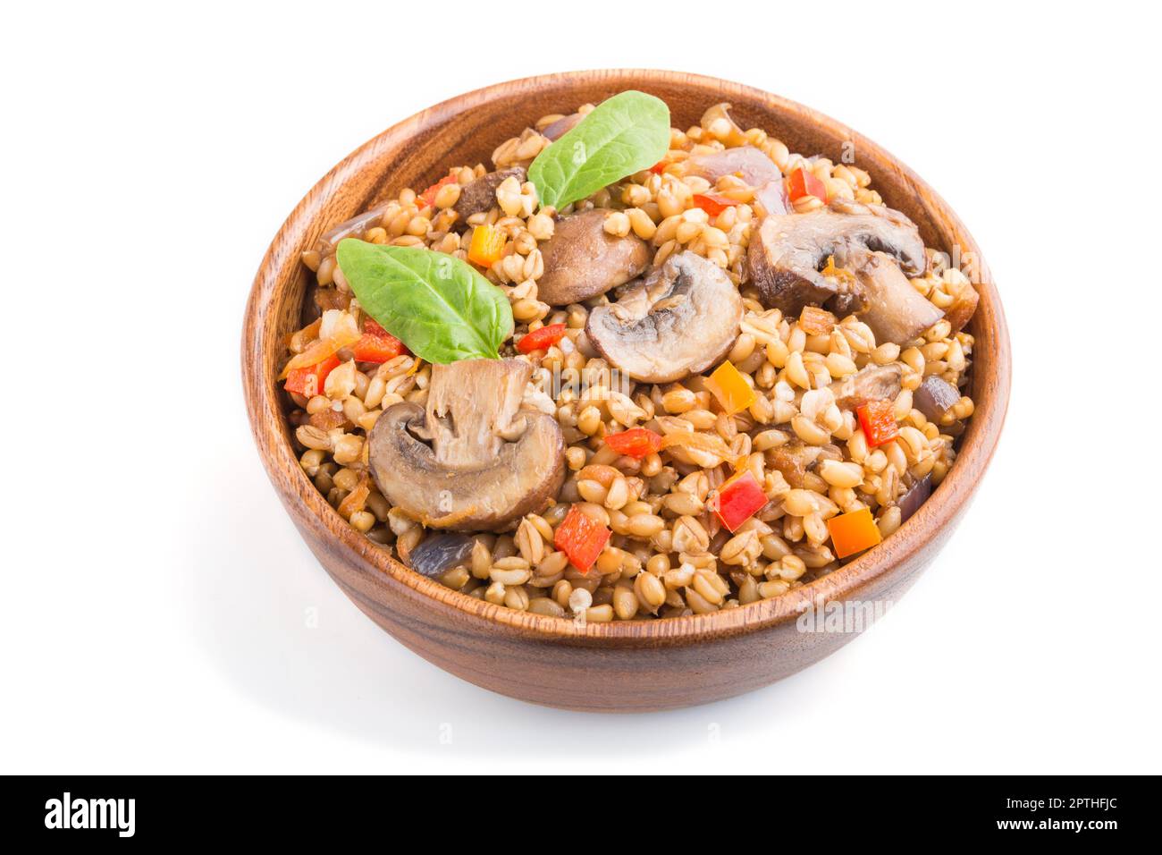 Spelt (dinkel wheat) porridge with vegetables and mushrooms in wooden ...