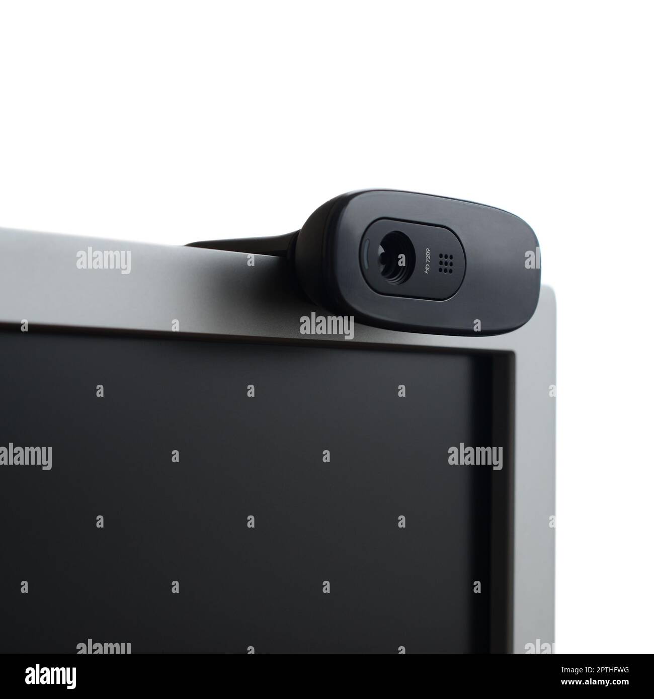 A modern web camera is installed on the body of a flat screen monitor ...