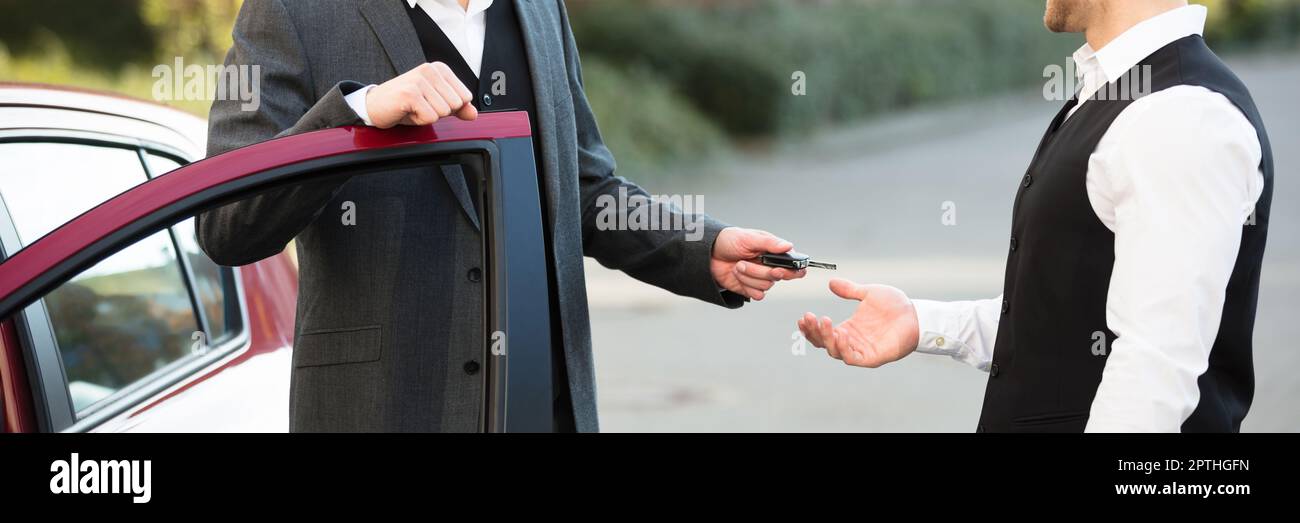 Valet Parking Car Service. Standing Near Door Giving Key Stock Photo