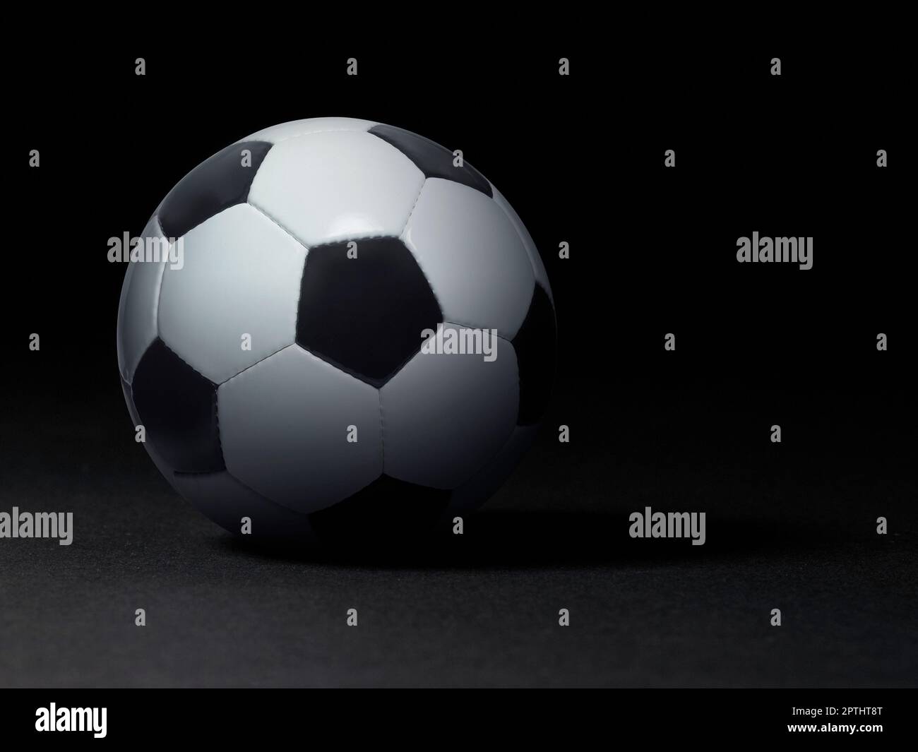 Soccer ball on black background Stock Photo - Alamy