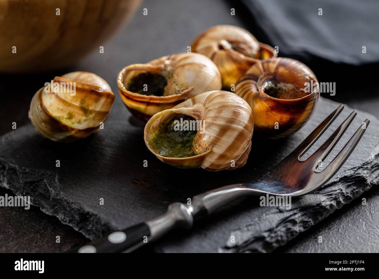 Snails with parsley butter, Bourgogne Escargot Snails on the cutting board. Delikatese food. Stock Photo