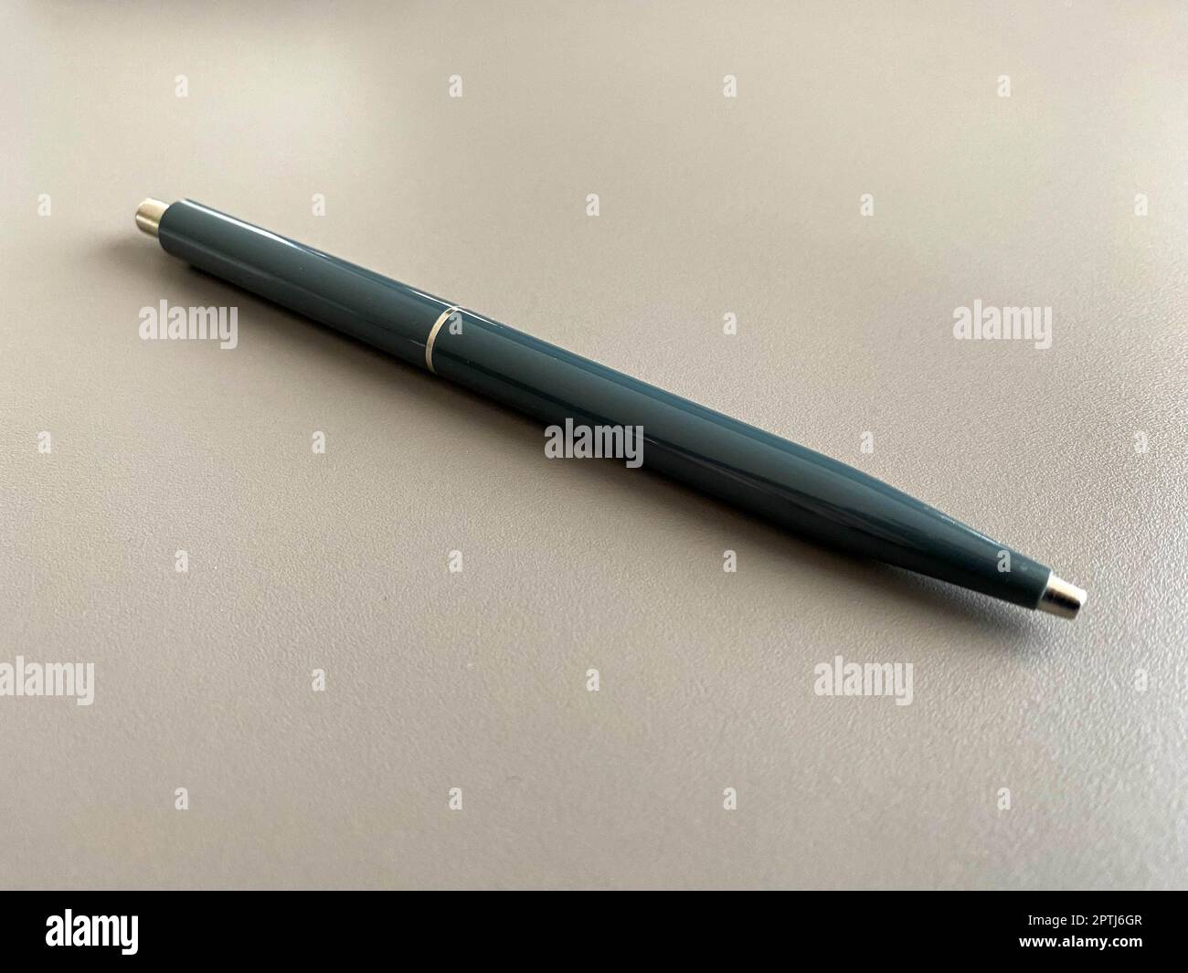Automatic green ballpoint pen for writing on your desktop office desk