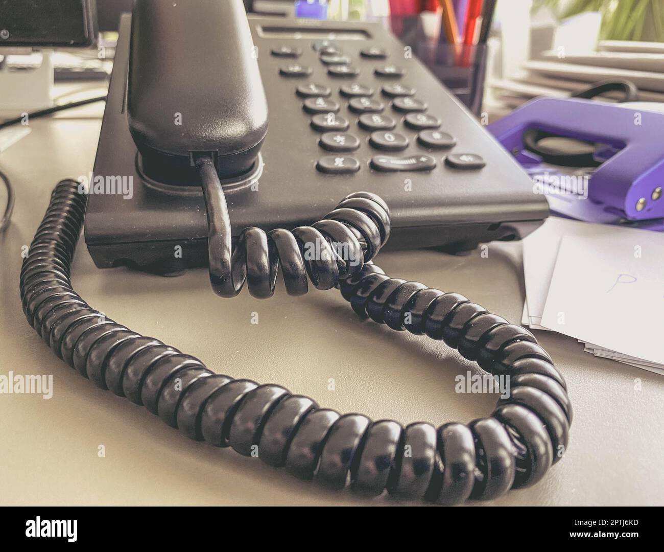 landline phone in the office on the table. black handset with buttons