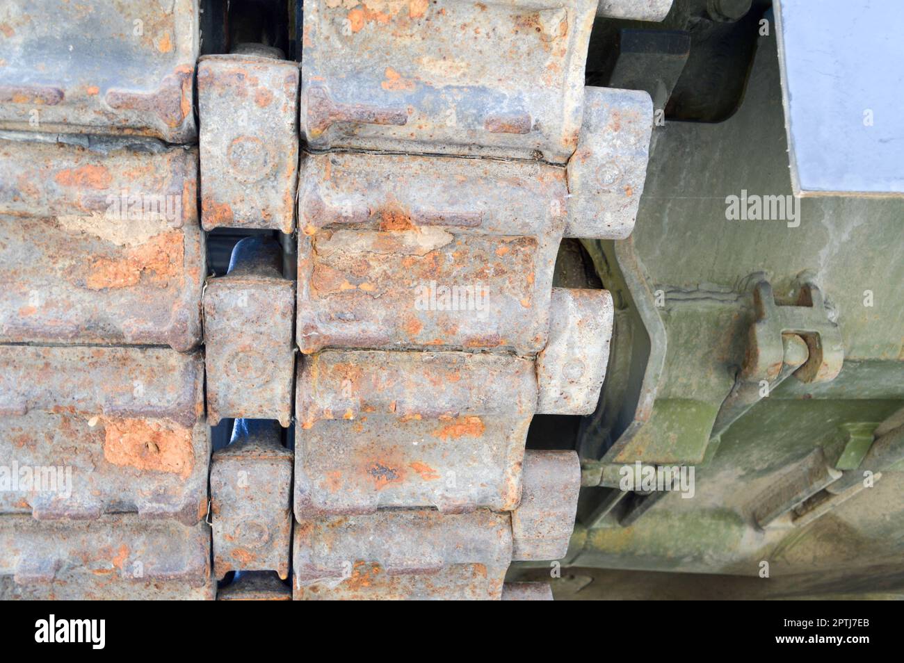 Rusty iron dirty metal heavy track caterpillar of a large green military off-road armored deadly dangerous Russian Syrian battle tank and bottom. Stock Photo