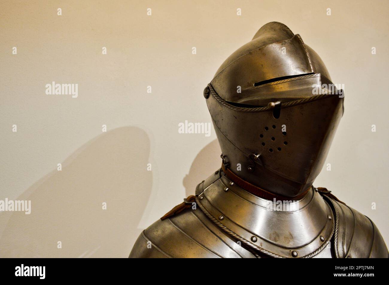 Medieval strong knight warrior chained in iron silvery strong metal armor with a helmet and a visor. Stock Photo