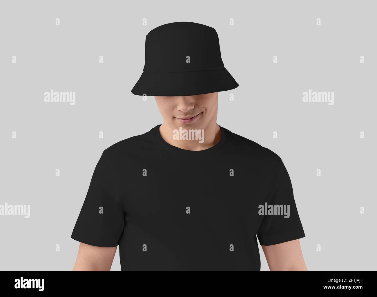 Black hat mockup on a smiling guy in a t-shirt, universal accessory for design, brand, print, pattern. Fashion headwear template, product photography Stock Photo