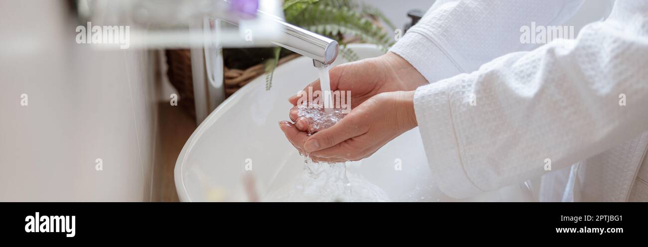 Woman washing her hands with soap in bathroom Stock Photo - Alamy