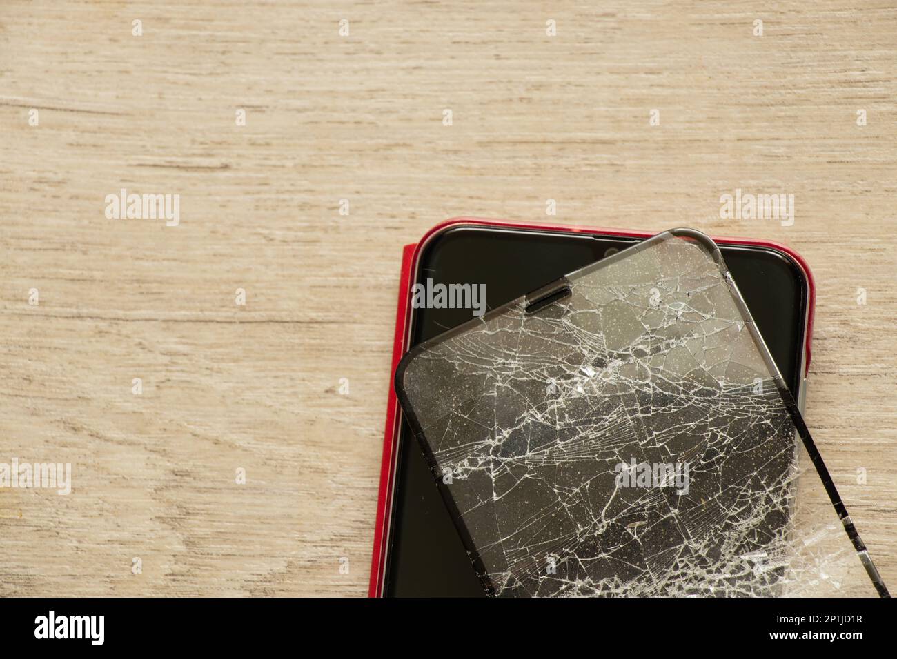 mobile phone and broken tempered glass on an isolated background, glass replacement Stock Photo