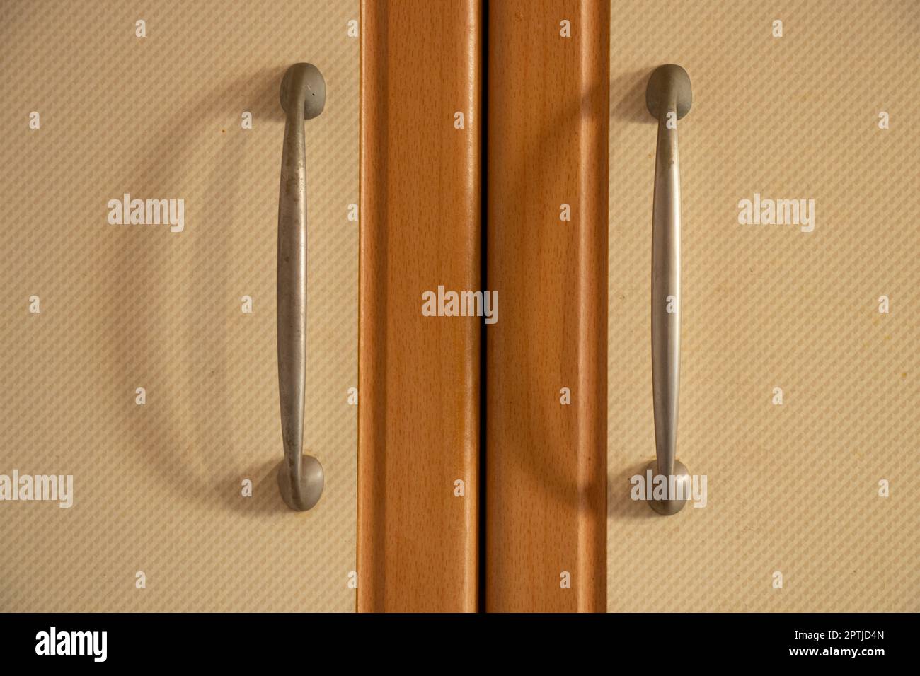 brown kitchen cabinet door handles in the kitchen Stock Photo