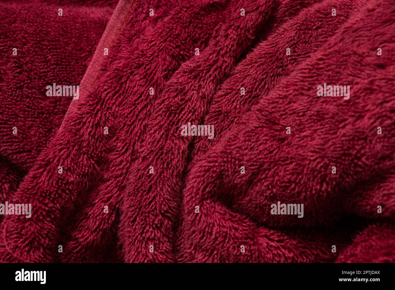 large red towel crumpled as a background close up Stock Photo