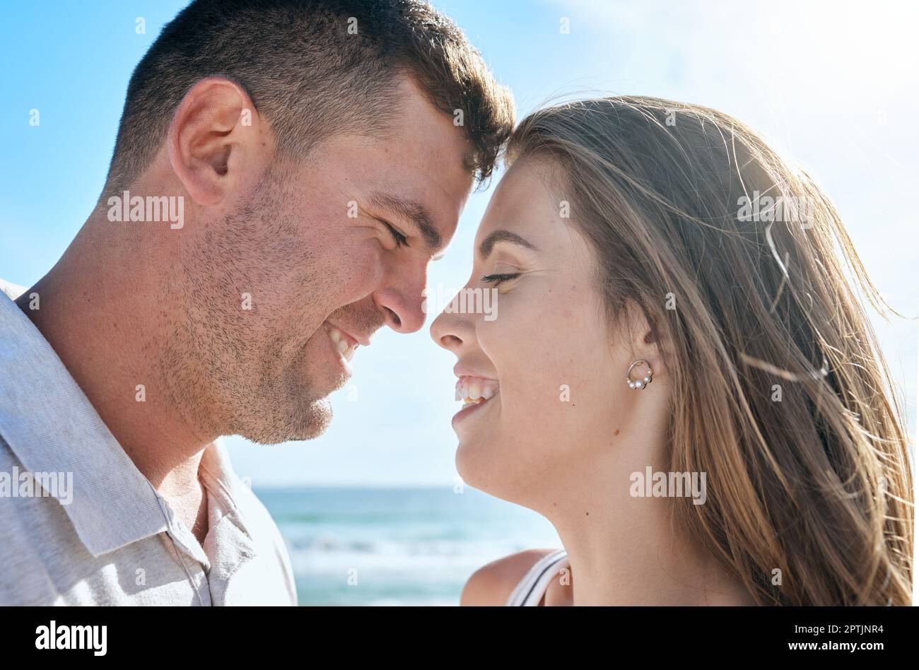 Couple, love and happy smile at beach, holiday and anniversary travel in summer with romance in Ibiza. Young man and woman enjoy marriage, happiness a Stock Photo