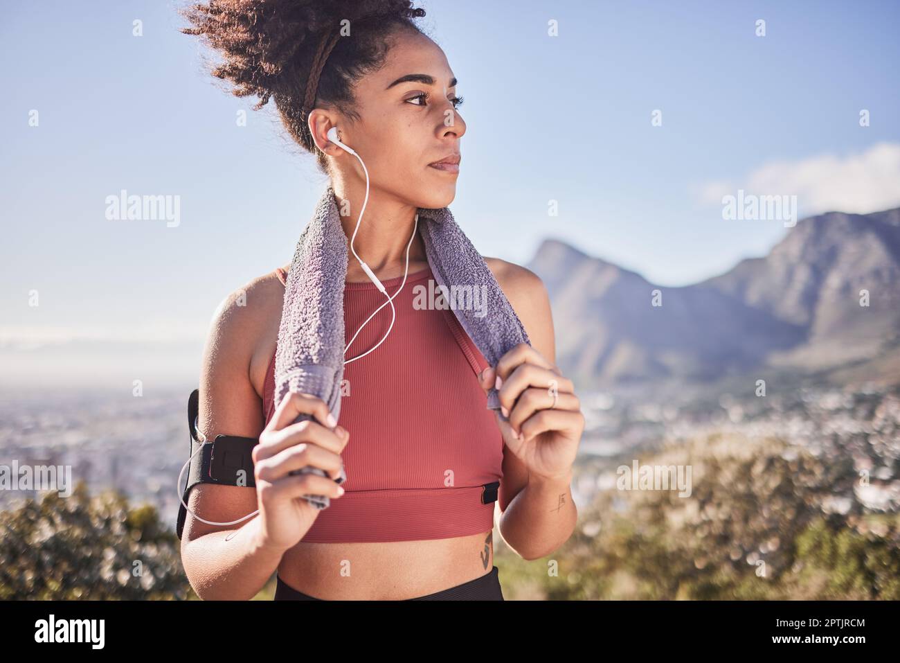 Sports, music and woman running in nature, stop for rest with view of  mountain and city, relax and calm. Radio, fitness and black woman with a  towel Stock Photo - Alamy