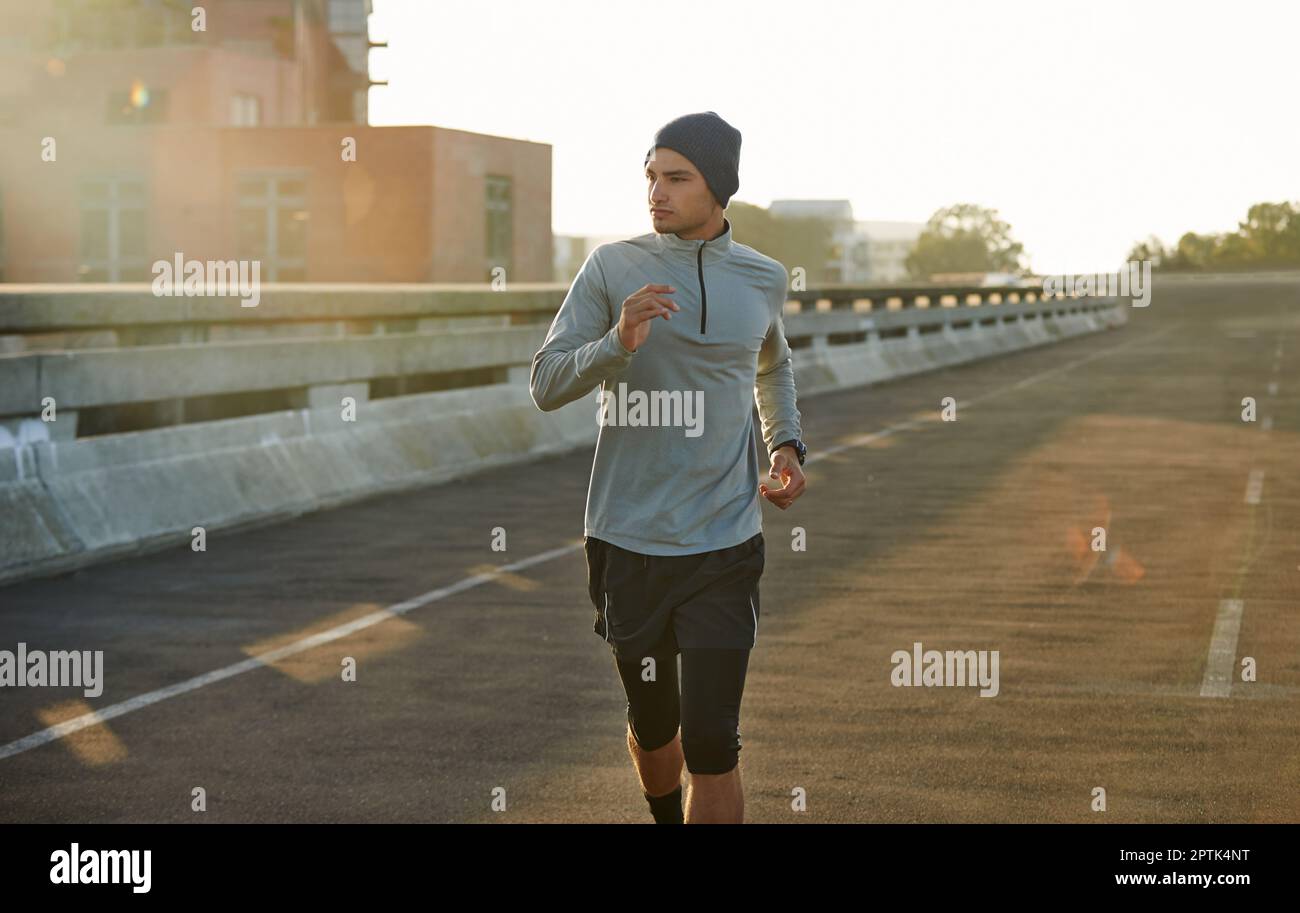 Early morning is the best time to run. a young male jogger out for a
