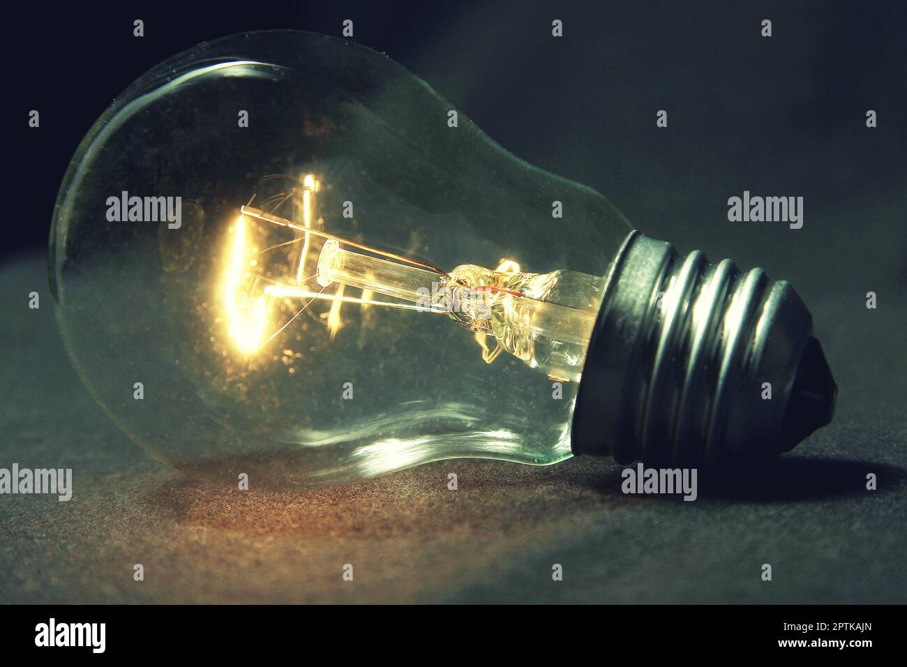 the light bulb glows without wires on the table Stock Photo