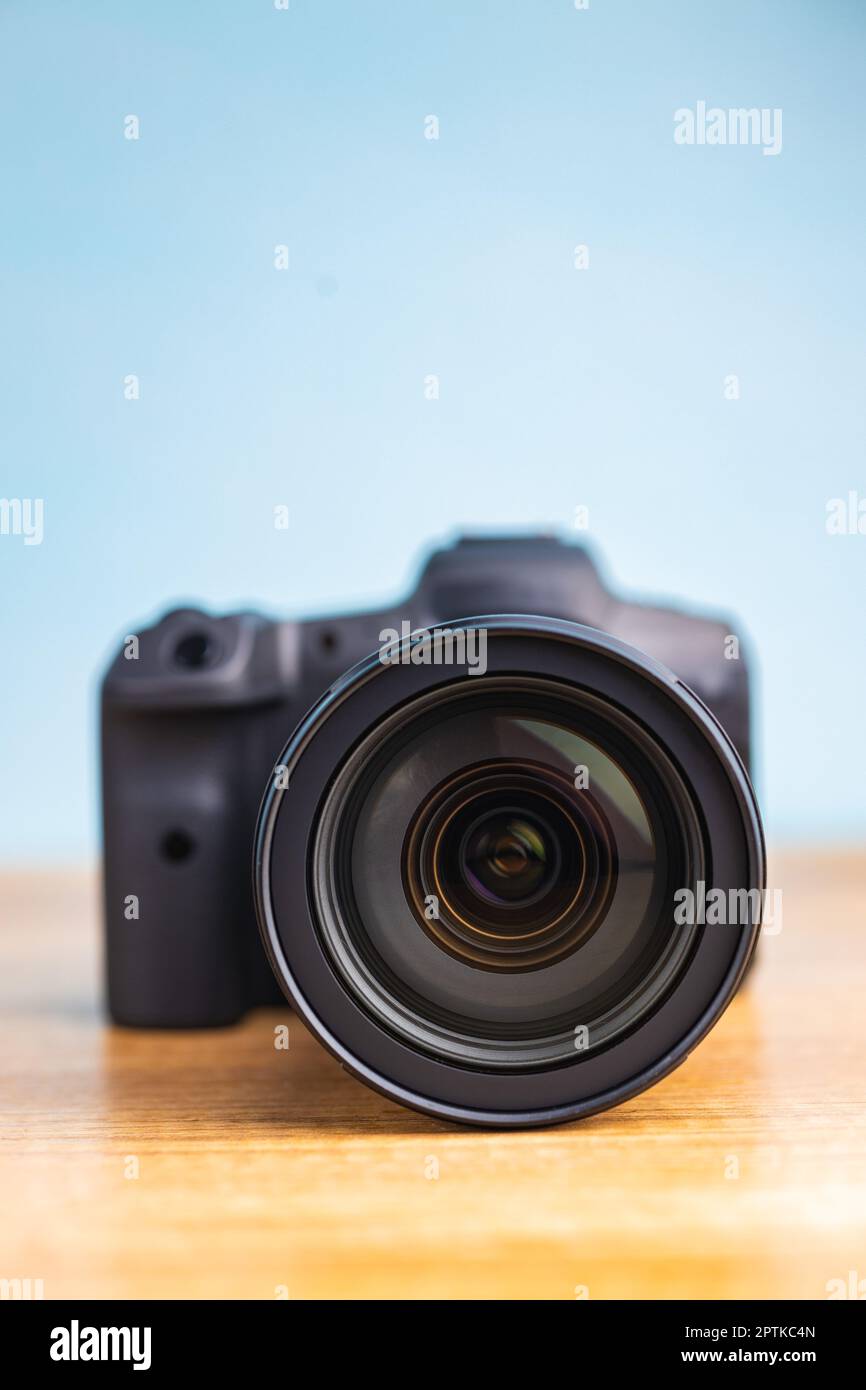 Digital mirrorless camera on the wooden table. Stock Photo