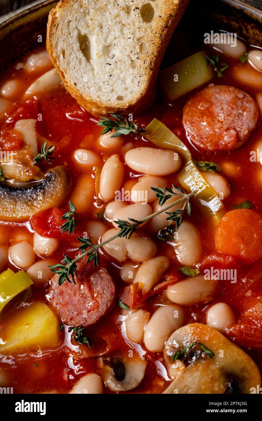 rustic bean soup with potatoes and sausages Stock Photo - Alamy