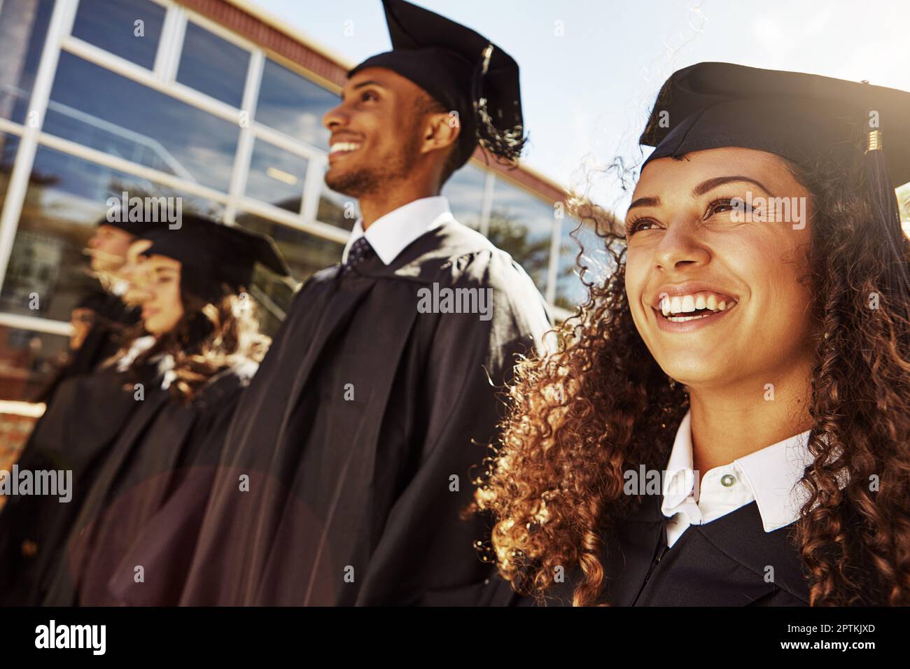 Theyve worked hard to get here today. a group of smiling university students outside on graduation day. Stock Photo