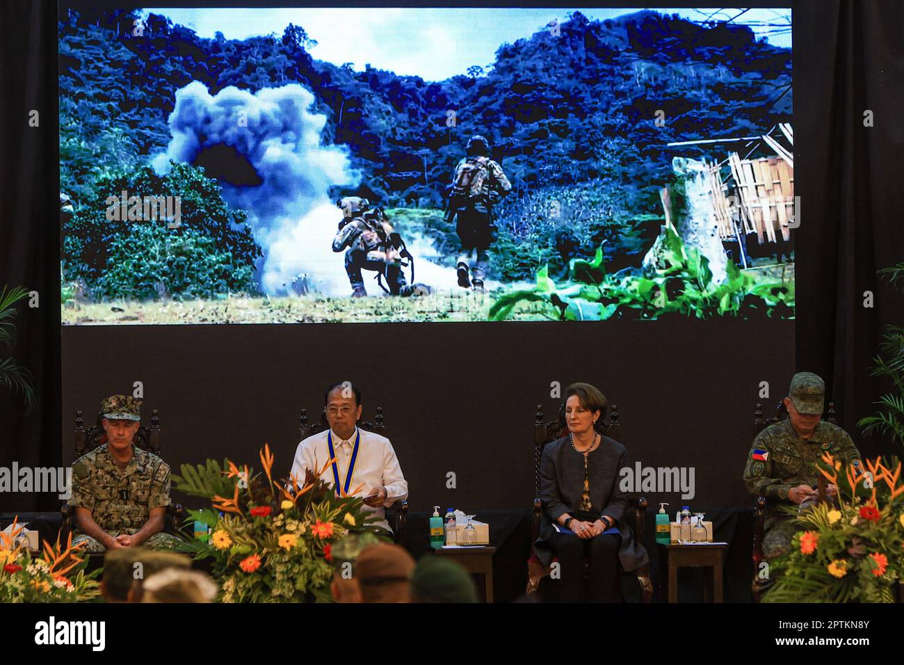 April 28, 2023, Quezon City, Metro Manila, The Philippines: US and Filipino officials as well as military officers watch a video played to conclude the Balikatan exercises, during the closing ceremony of the US-Philippines Balikatan Exercises at a military base in Quezon City. The month-long bilateral exercises which started in April involved soldiers from both the United States and The Philippines holding live-fire training, with observers from Japan, Australia and more to learn more about their military capabilities and collaborations in the Indo-Pacific region where geopolitical tensions ha Stock Photo