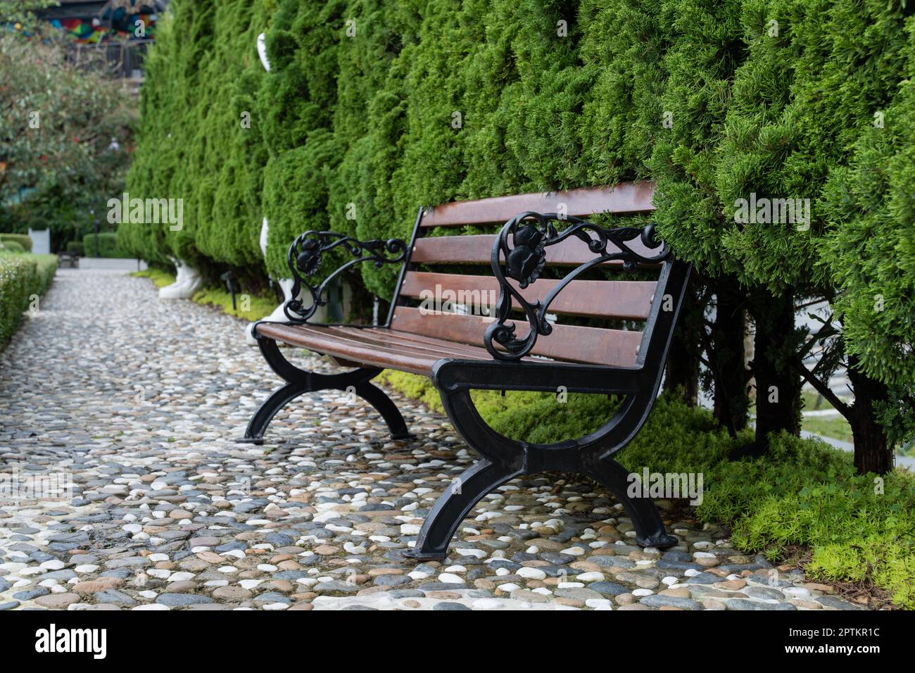 Stylish bench in the spring garden. Bench in city park Stock Photo