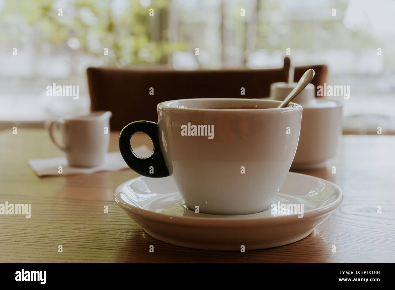 Cup of coffee with milk. Morning coffee in cafe. Coffeehouse interior. Hot drinks concept