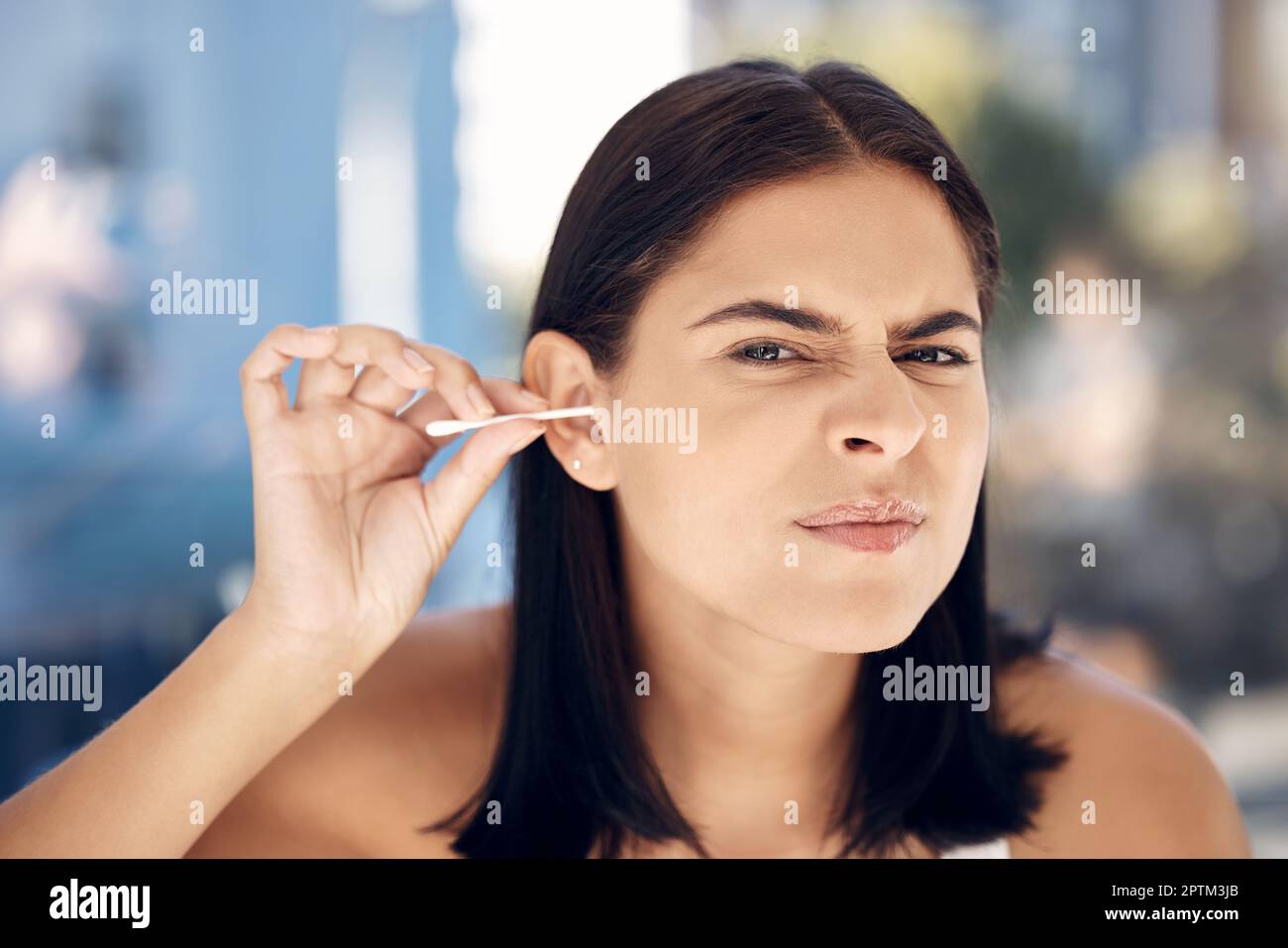 Ear, cleaning and woman in a bathroom for grooming, hygiene and daily