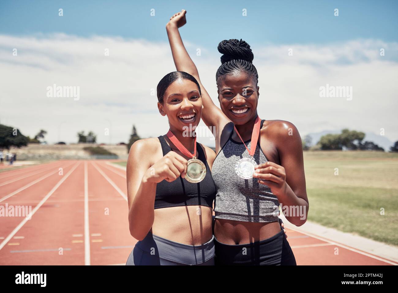 Portrait, success medals and women at stadium after winning running