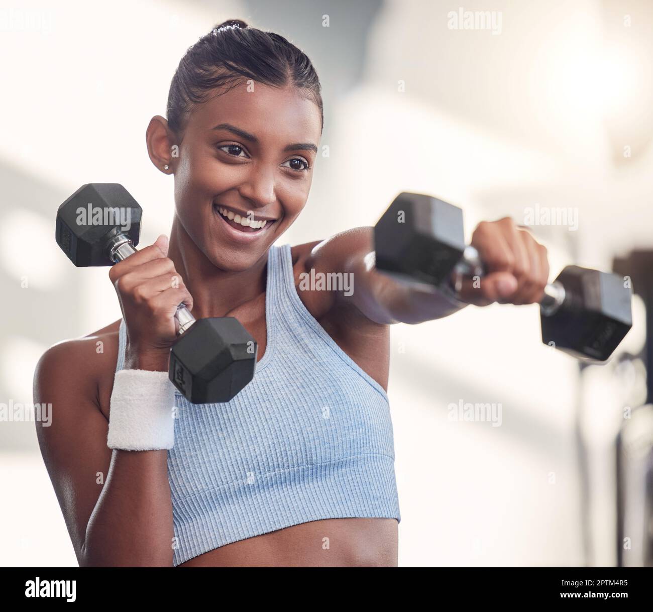 Beautiful healthy happy smiling black asian woman with dumbbell