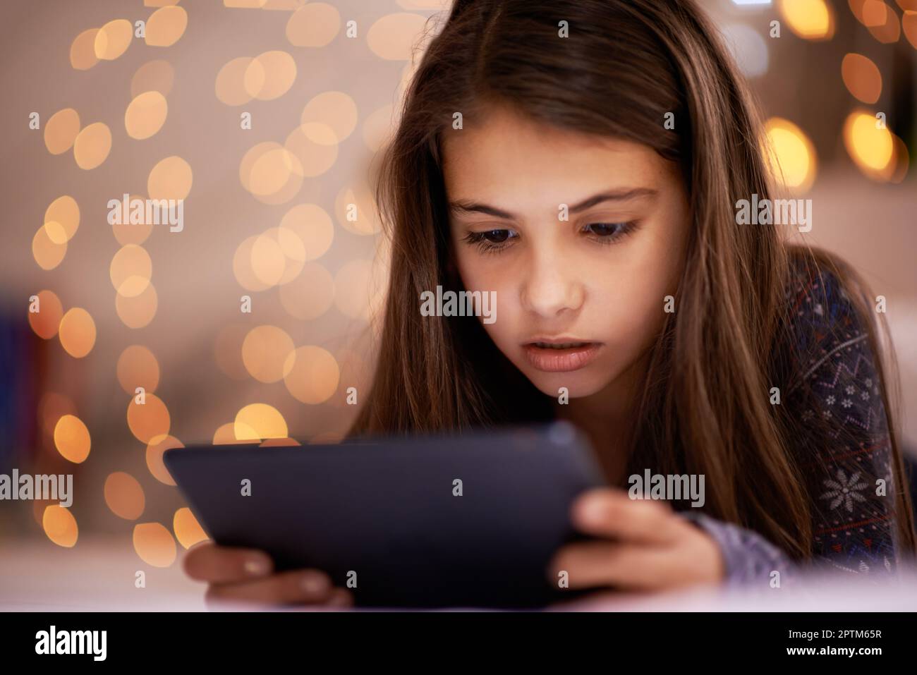 Who knew you could find so many things on the internet. a cute little girl using a digital tablet Stock Photo