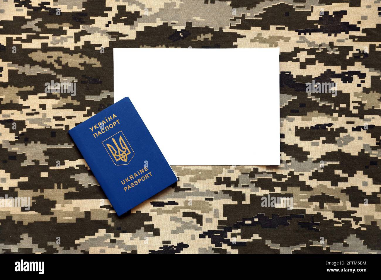 Ukrainian foreign passport on fabric with texture of military pixeled