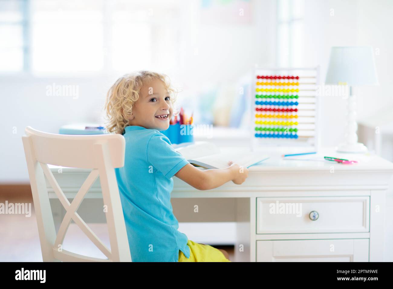 Child doing homework at home. Little boy with wooden colorful abacus ...