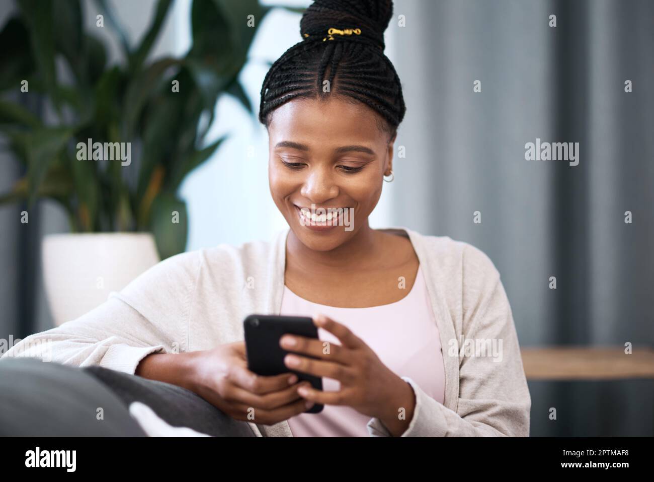 Phone, relax and happy black woman in her living room networking on ...