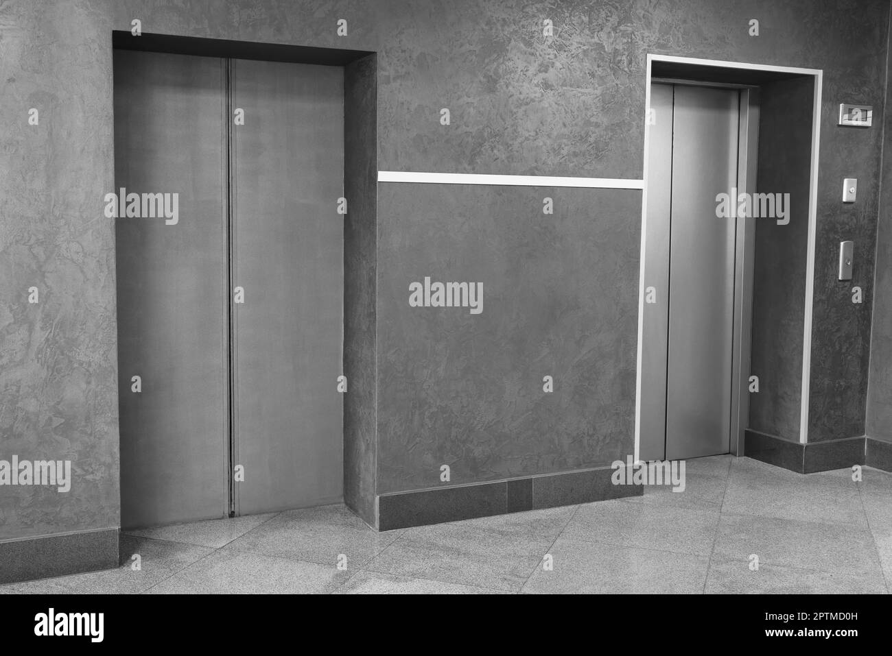 Closed stylish elevator doors in clean hall Stock Photo