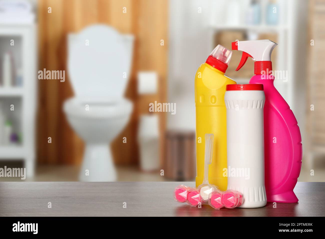 https://c8.alamy.com/comp/2PTMERK/different-toilet-cleaning-supplies-on-wooden-table-in-bathroom-space-for-text-2PTMERK.jpg