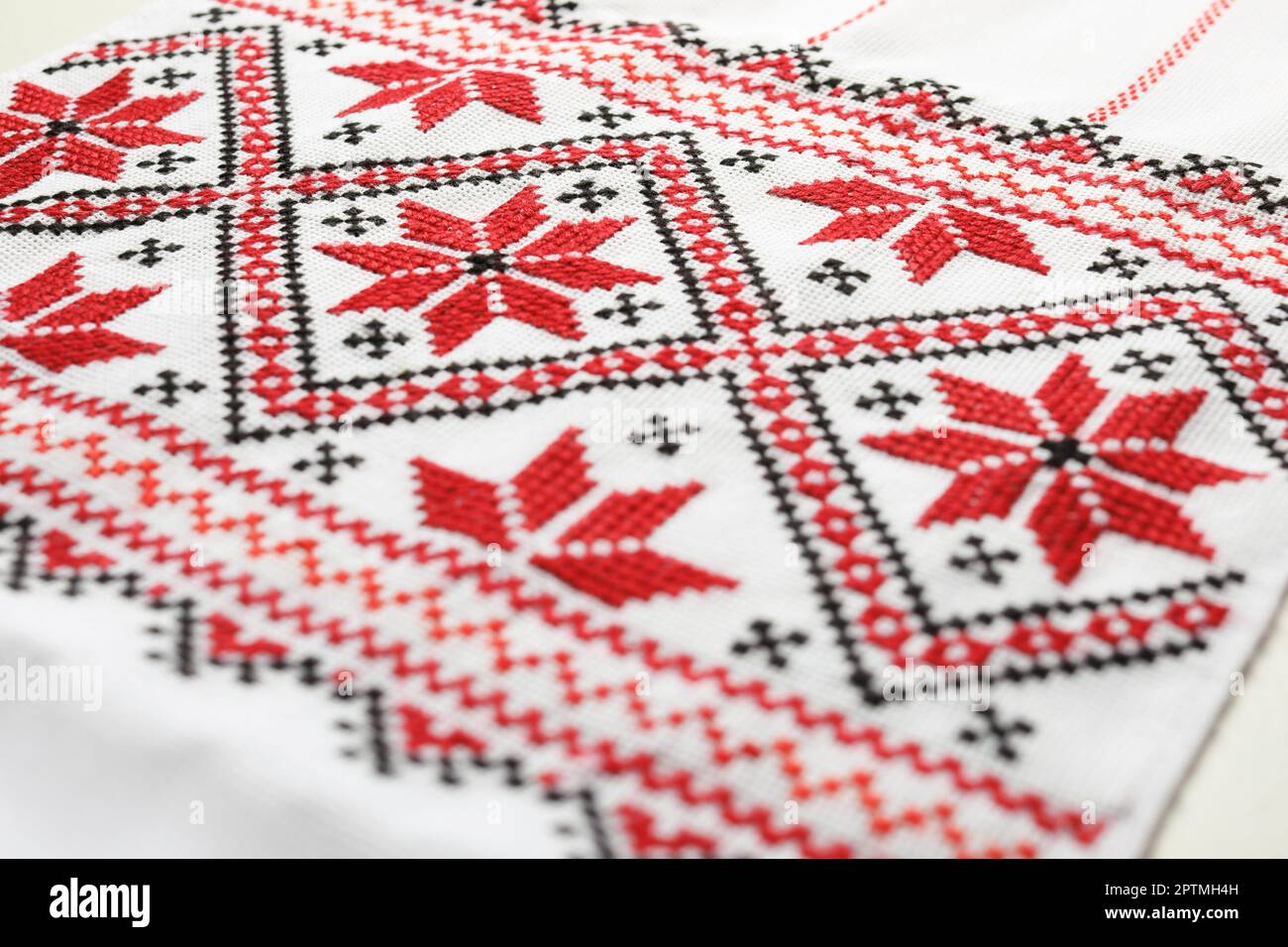 Traditional Ukrainian embroidery on white canvas, closeup. National handicraft Stock Photo