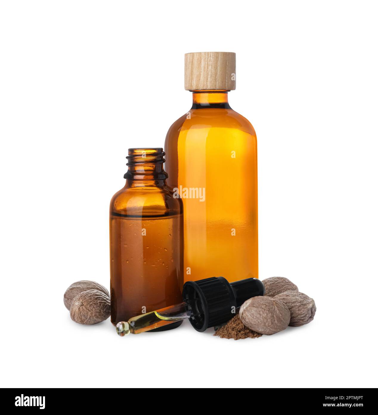 Bottles of nutmeg oil, nuts and pipette on white background Stock Photo