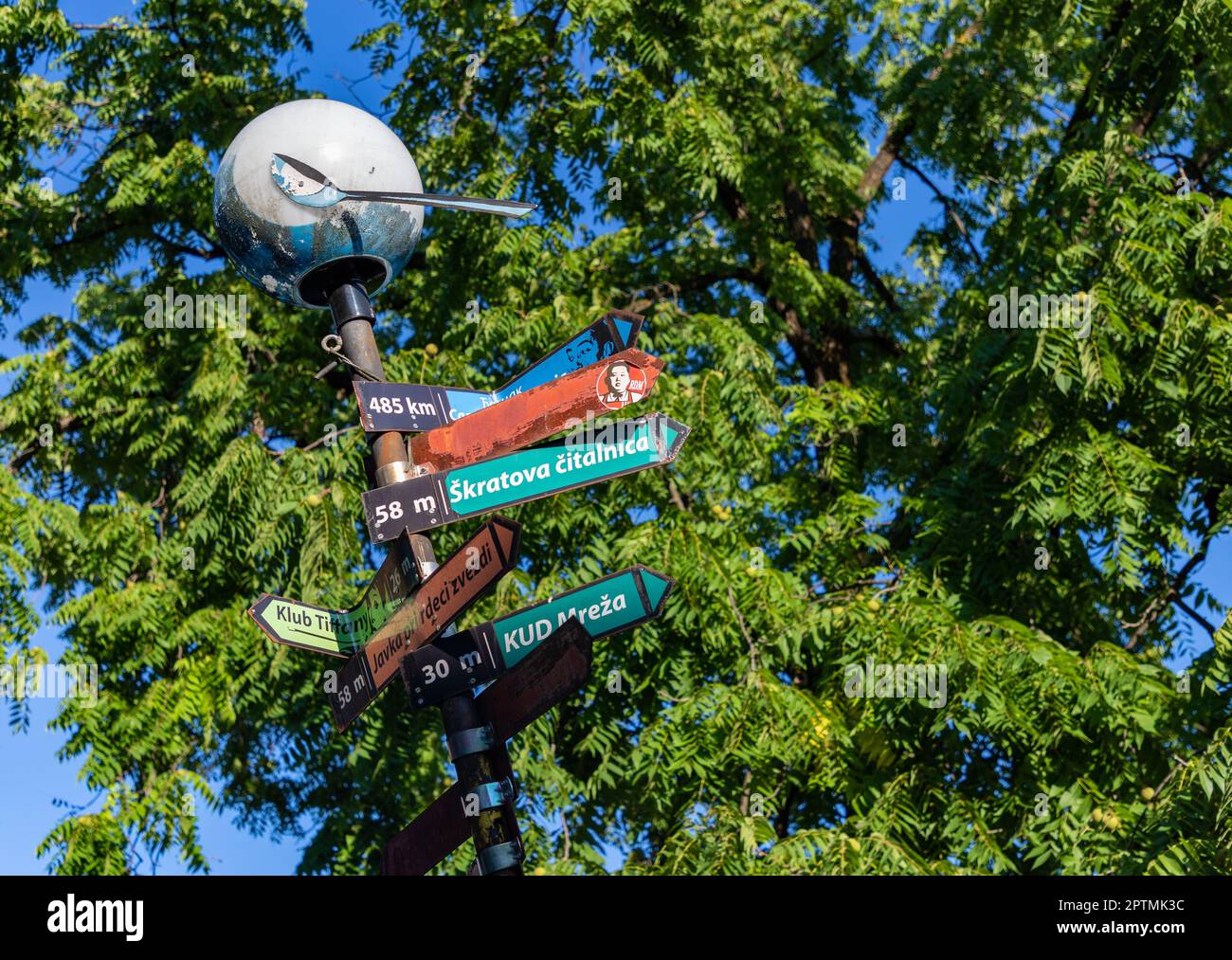 A picture of alternative direction signs on display at the Metelkova ...