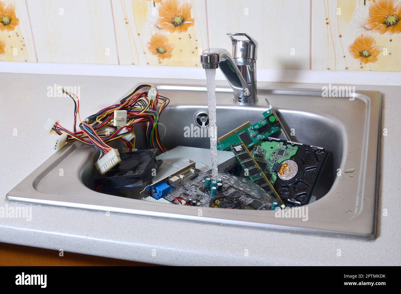 Personal computer cleaning metaphoric concept. Hardware in kitchen sink under the water flow