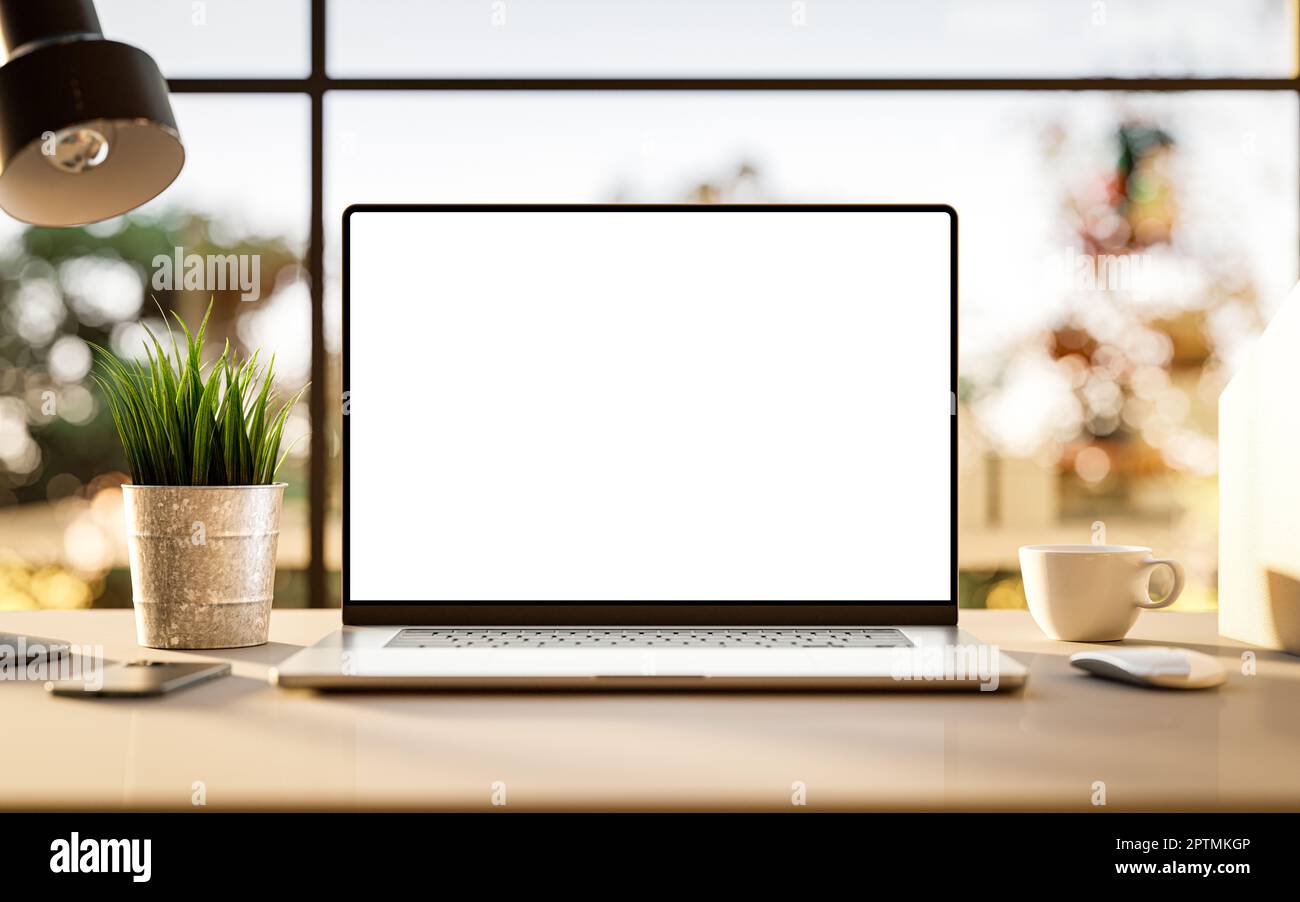 Laptop with blank frameless screen mockup template on the table in industrial office loft interior - front view Stock Photo