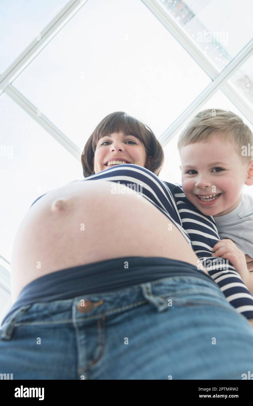 Portrait of pregnant woman holding her belly Stock Photo - Alamy