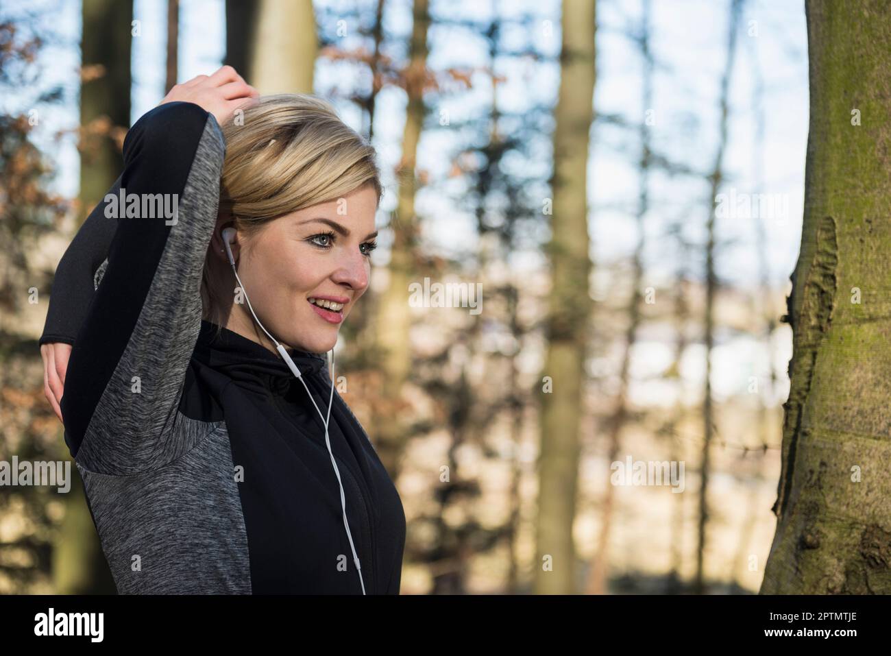 Athlete stretching in forest hi-res stock photography and images - Alamy