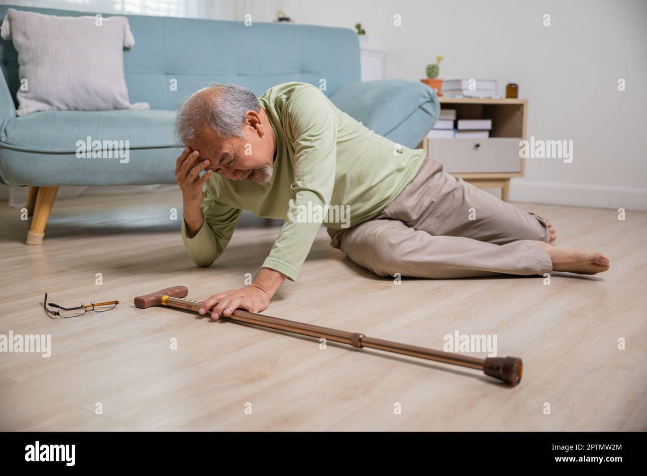 Older senior man headache lying on the floor after falling down he pain