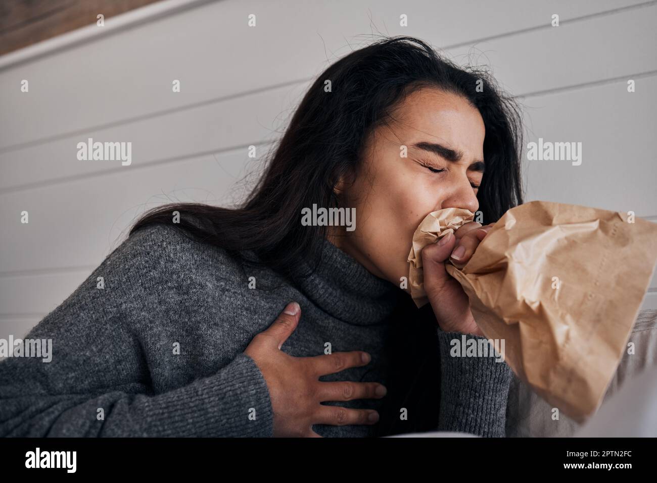 Woman, anxiety and stress paper bag breathing of a woman with mental