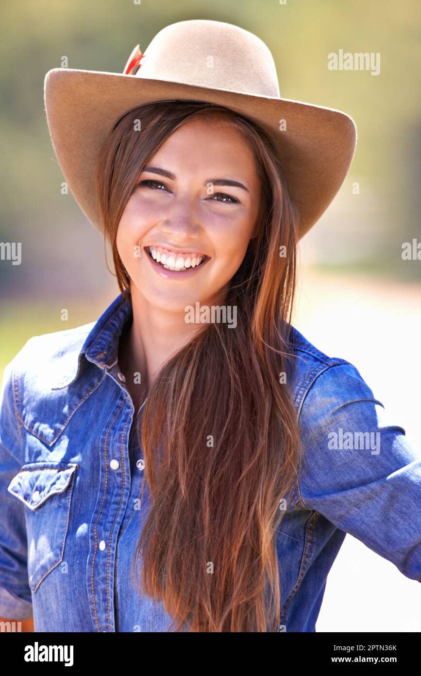Howdy, partner. A beautiful young woman in a cowgirl outfit standing outdoors Stock Photo