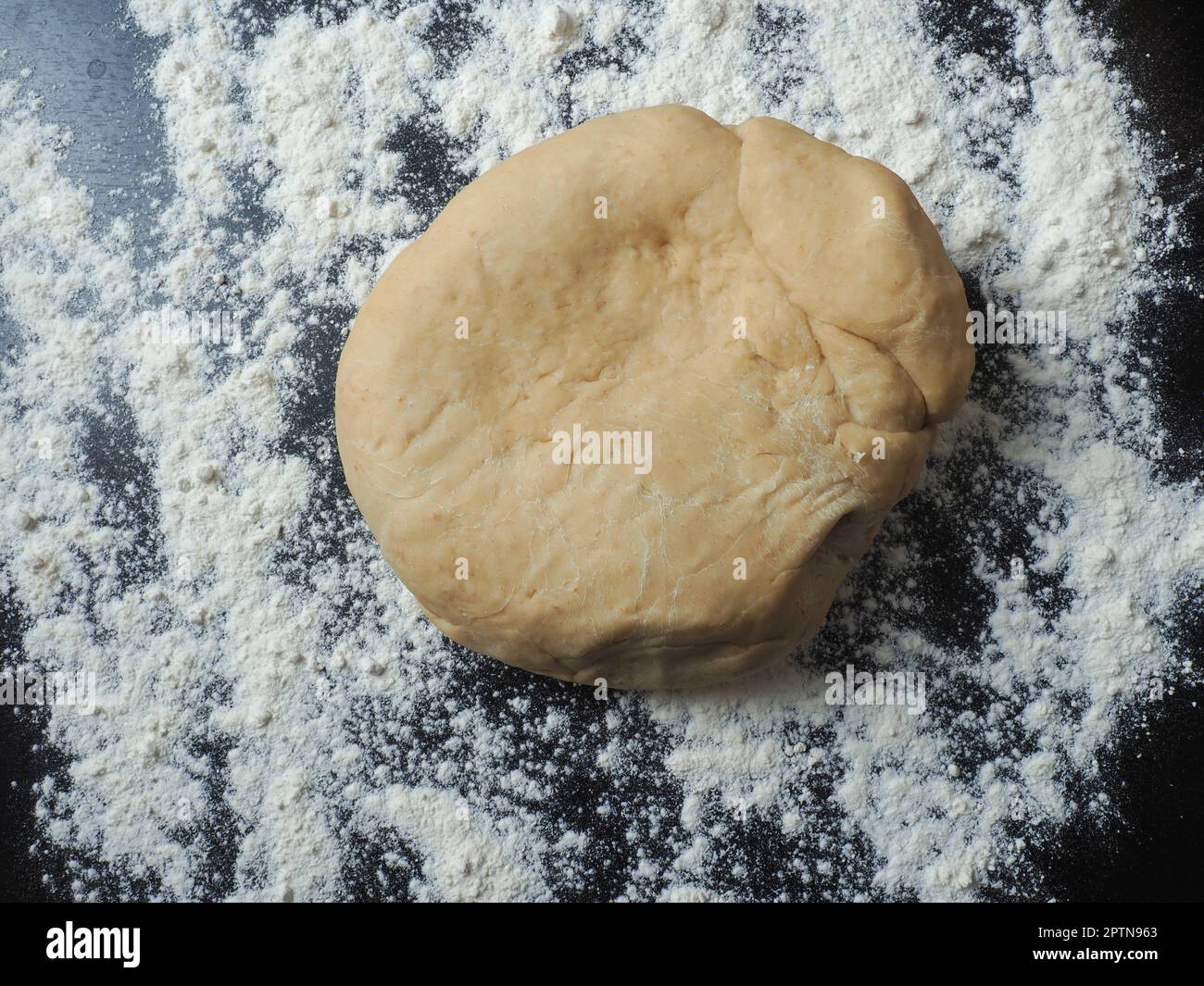 Fresh yeast dough with flour on a kitchen countertop Stock Photo - Alamy
