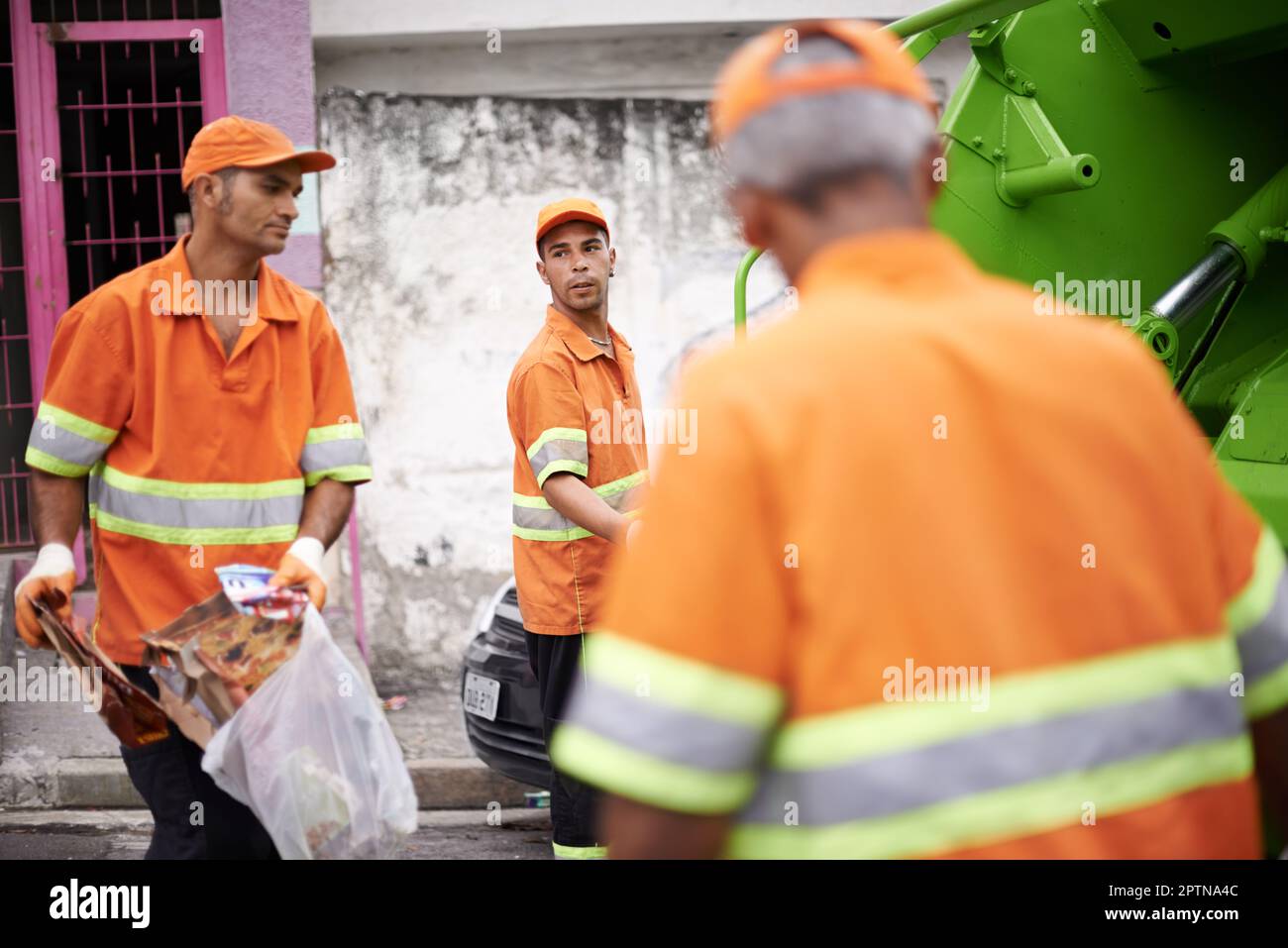 Garbage collection day. a garbage collection team at work Stock Photo